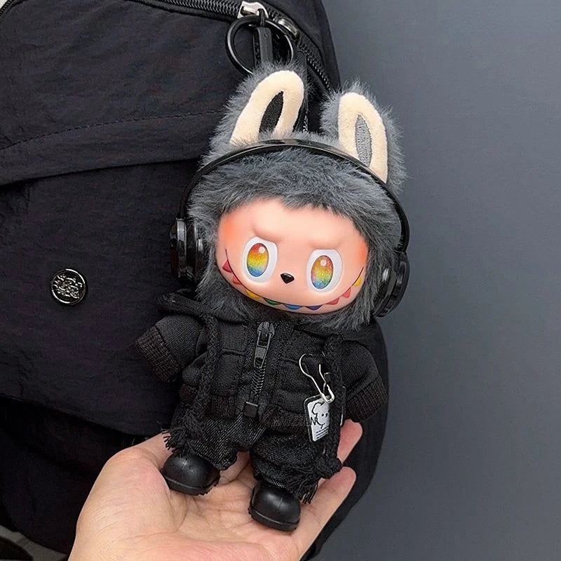 Labubu doll outfit set featuring a black bear hoodie and headphones held in a hand.