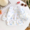 A white full-sleeve waterproof baby bib featuring a cute cartoon design of bears and geometric shapes.