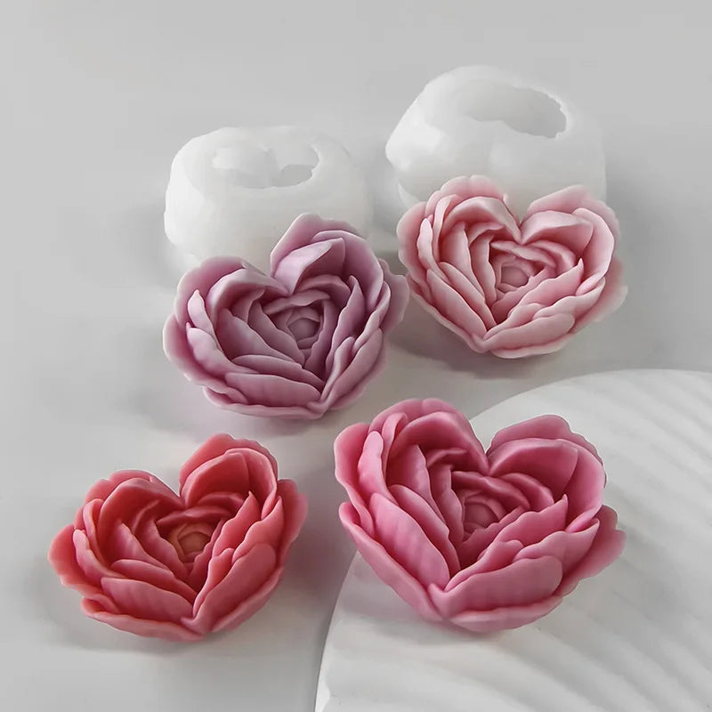 A collection of heart-shaped pink and white silicone molds for crafts and candles.