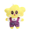 A yellow plush pendant doll resembling a cartoon character with large eyes and white flowers.