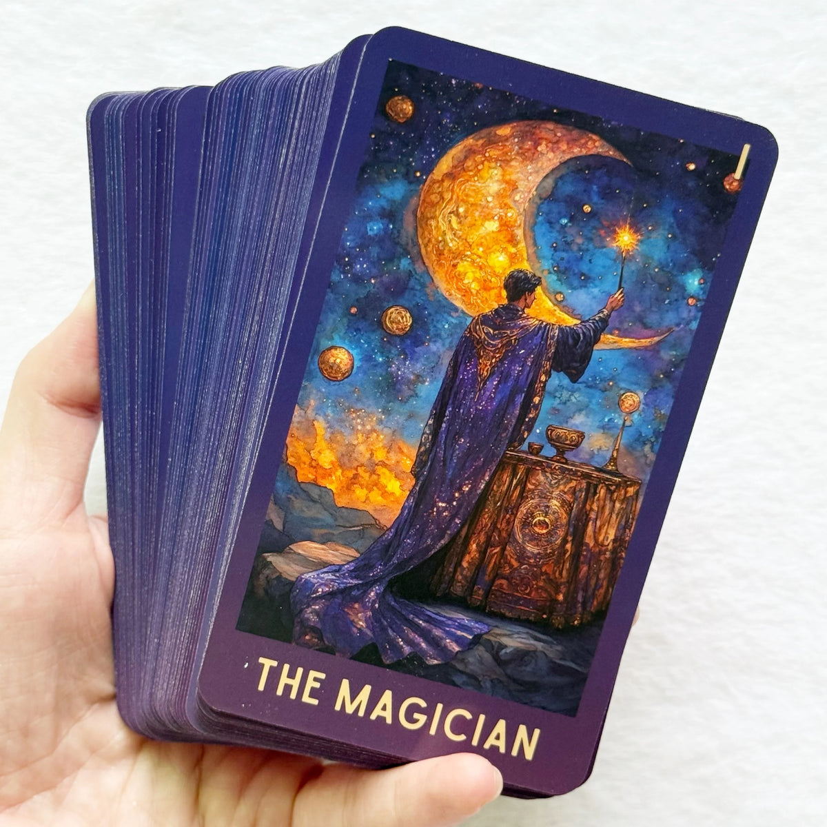 A tarot card depicting The Magician with a purple cloak and golden light against a starry night sky.