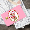 Pink card with a cute strawberry and shortcake illustration on a background of money.