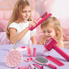 A set of pink and purple pretend play hair styling tools including a hairdryer, combs, brushes, and rollers used by a child.