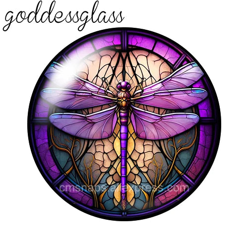 A round glass cabochon featuring a purple dragonfly design with intricate details.