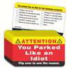 A yellow parking violation card with checkboxes and a red box warning you parked like an idiot.