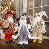 A festive figurine of Santa Claus with a white beard and red hat, dressed in plaid and fur clothing.