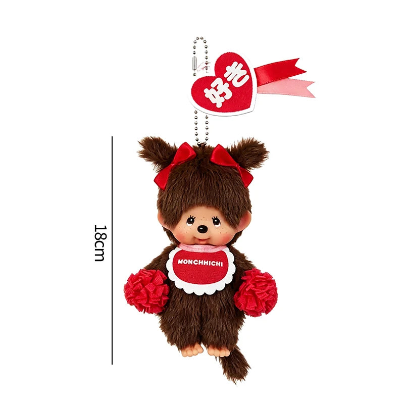 A brown plush cartoon bear with red accents and a pink ribbon charm.