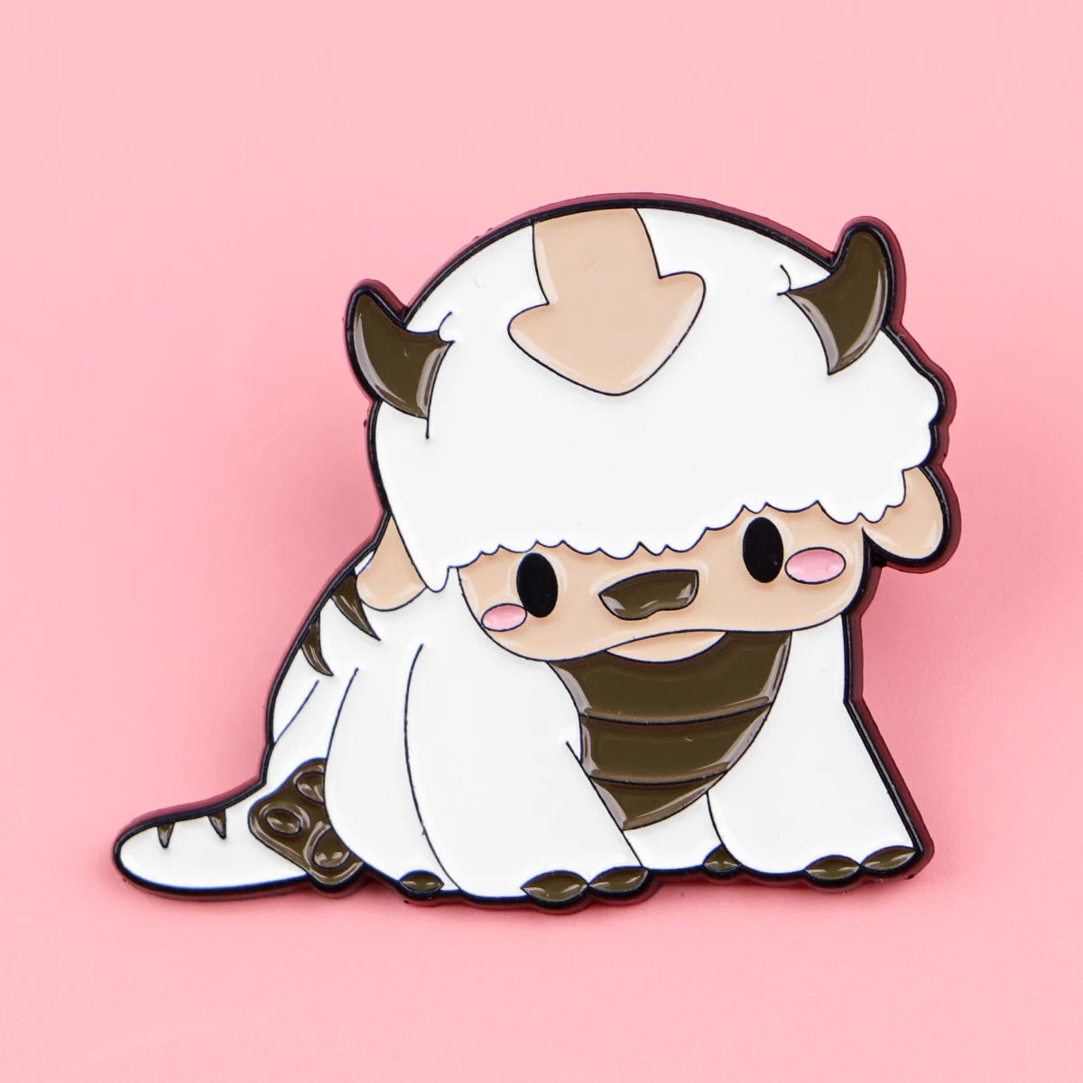 A white cat-like character enamel pin featuring horns and a cute expression.