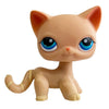 A small, light orange cat bobble head figurine with large blue eyes and yellow accents.