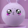 A smooth, light purple inflatable hopper ball with black and white spotted features rests on a pink stand.