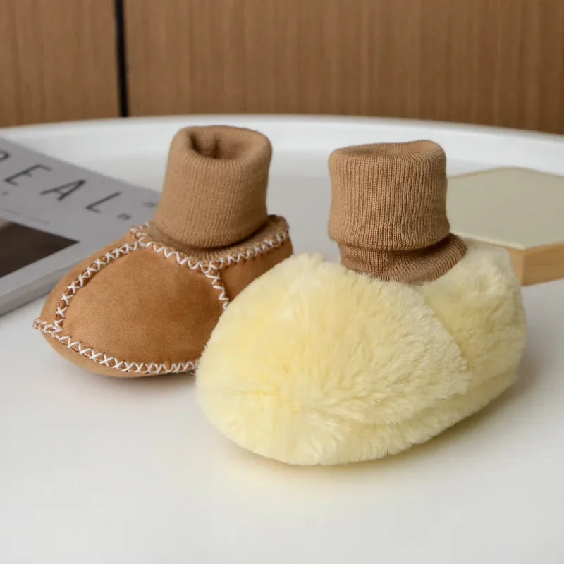 Pair of tan suede baby booties with knitted cuff and a fluffy cream fur lining