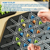 A close-up view of a triangle chess strategy board game with pieces and a player's hand setting up the game.