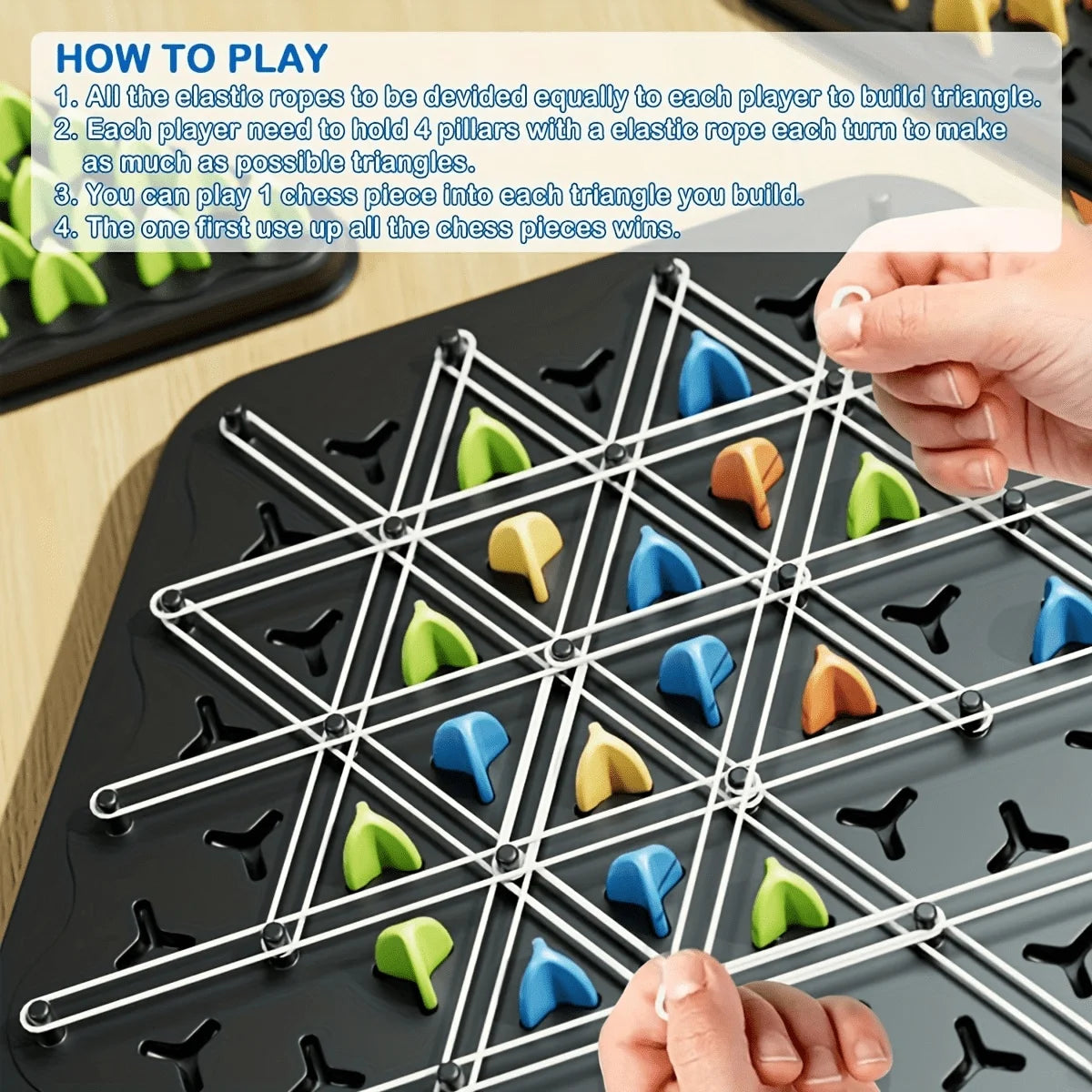 A close-up view of a triangle chess strategy board game with pieces and a player's hand setting up the game.