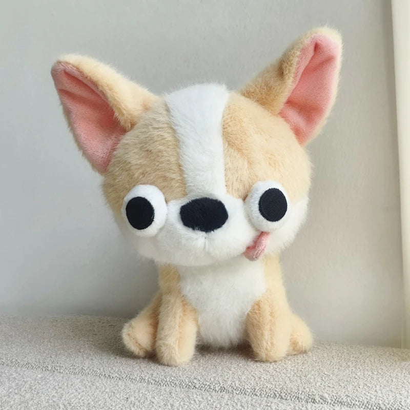 A fluffy chihuahua plush doll with light tan and white fur, featuring large eyes and a tongue sticking out.