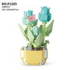 A set of light green and pink floral building blocks shaped like succulents and a butterfly, displayed on a yellow base.