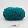 A ball of teal pre-dyed milk cotton yarn used for knitting and crochet.
