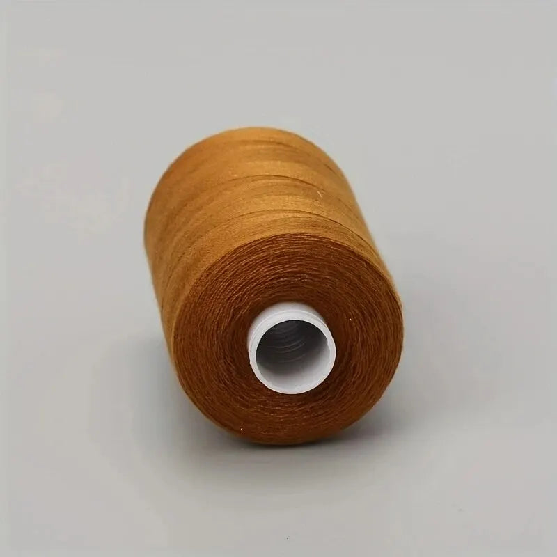 A roll of brown polyester sewing thread is shown against a light gray background.
