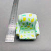 A light green PVC figurine shaped like a school bus with yellow cartoon watermelon designs.