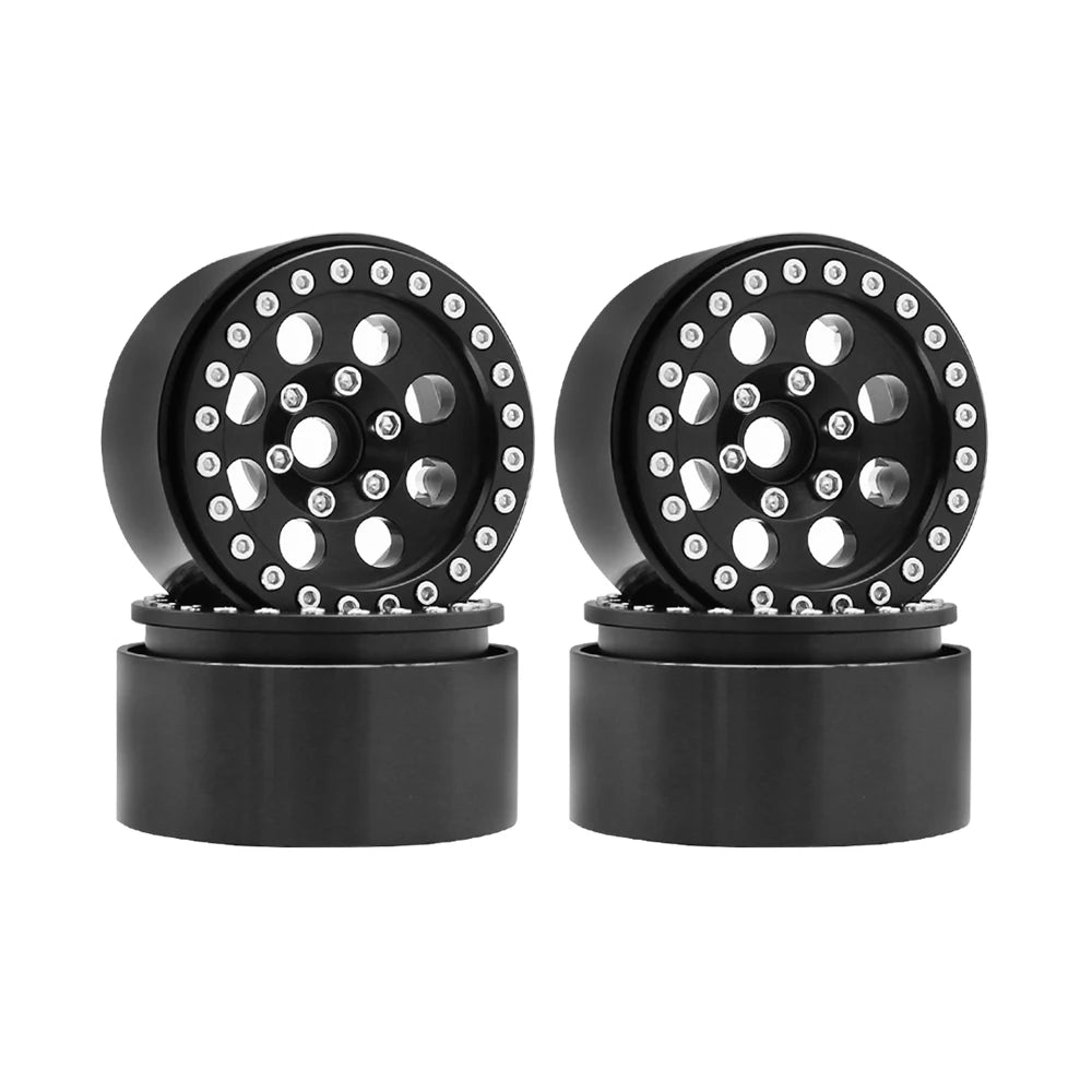 Two black metal beadlock wheels with removable hex hubs for an RC crawler.