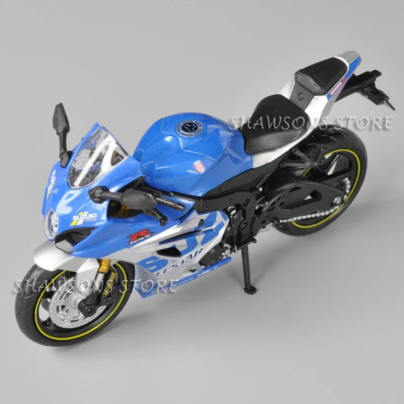 A blue and white Suzuki GSX-R1000R diecast motorcycle model in a display setting.