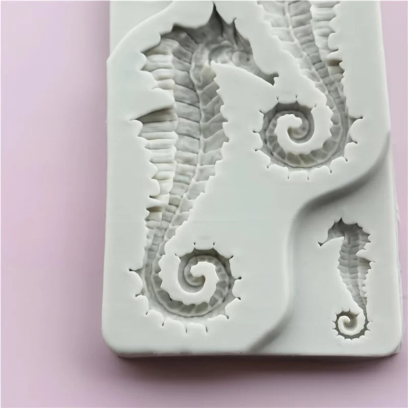 A silicone mold featuring detailed, intricate seahorse shapes for resin and clay crafts.