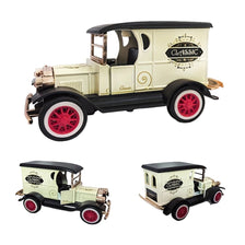 A vintage die-cast car model featuring a cream body, black fenders, and red wheels with classic lettering.