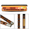 An open traditional Chinese bamboo flute (dizi) with a brass joint, shown alongside disassembled parts.