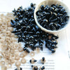 A bowl filled with small black plastic safety eyes for crafting and doll making