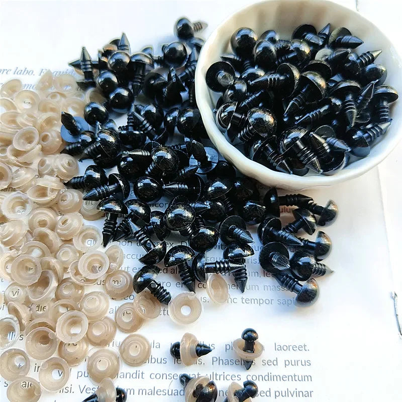A bowl filled with small black plastic safety eyes for crafting and doll making
