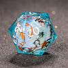 A translucent blue polyhedral die with a galaxy finish rests on a dark, textured surface.