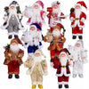 A collection of various Christmas Santa Claus figurines in different outfits and sizes for holiday decor