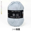 A ball of light blue milk cotton yarn labeled for international color standards and marked as 14# washing.