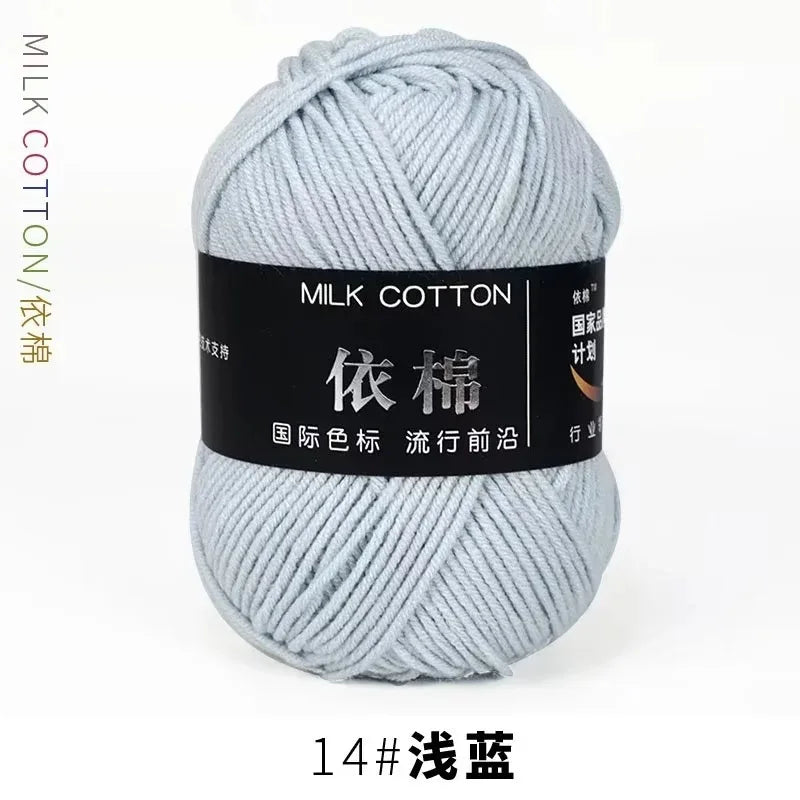 A ball of light blue milk cotton yarn labeled for international color standards and marked as 14# washing.