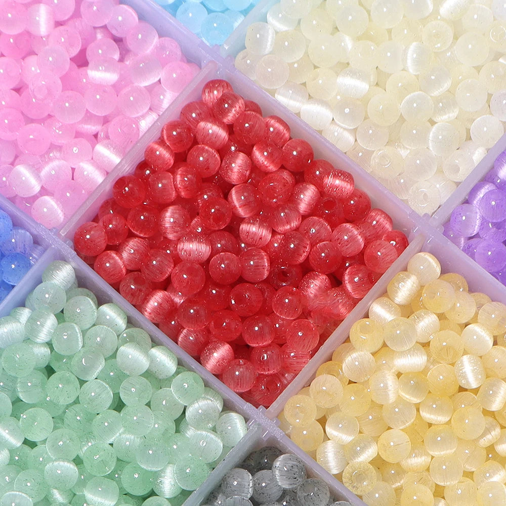 A colorful mix of 4mm cat eye glass beads in various shades including pink, red, green, and yellow.