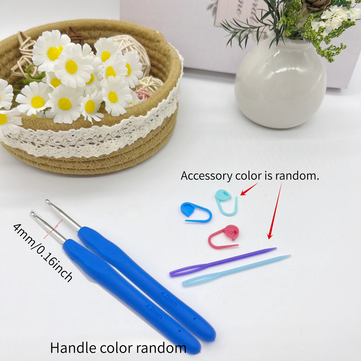 A set of crochet hooks, stitch markers, and needles with various colors displayed next to a woven basket and a white vase.