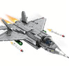 A gray J35 fighter jet model kit is shown in flight with missile trails against a white background.
