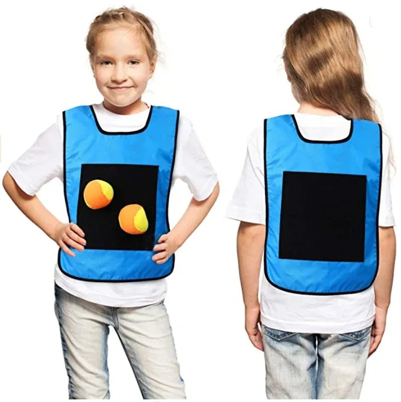 A child is shown wearing a blue and black sticky dodgeball vest for an outdoor game.