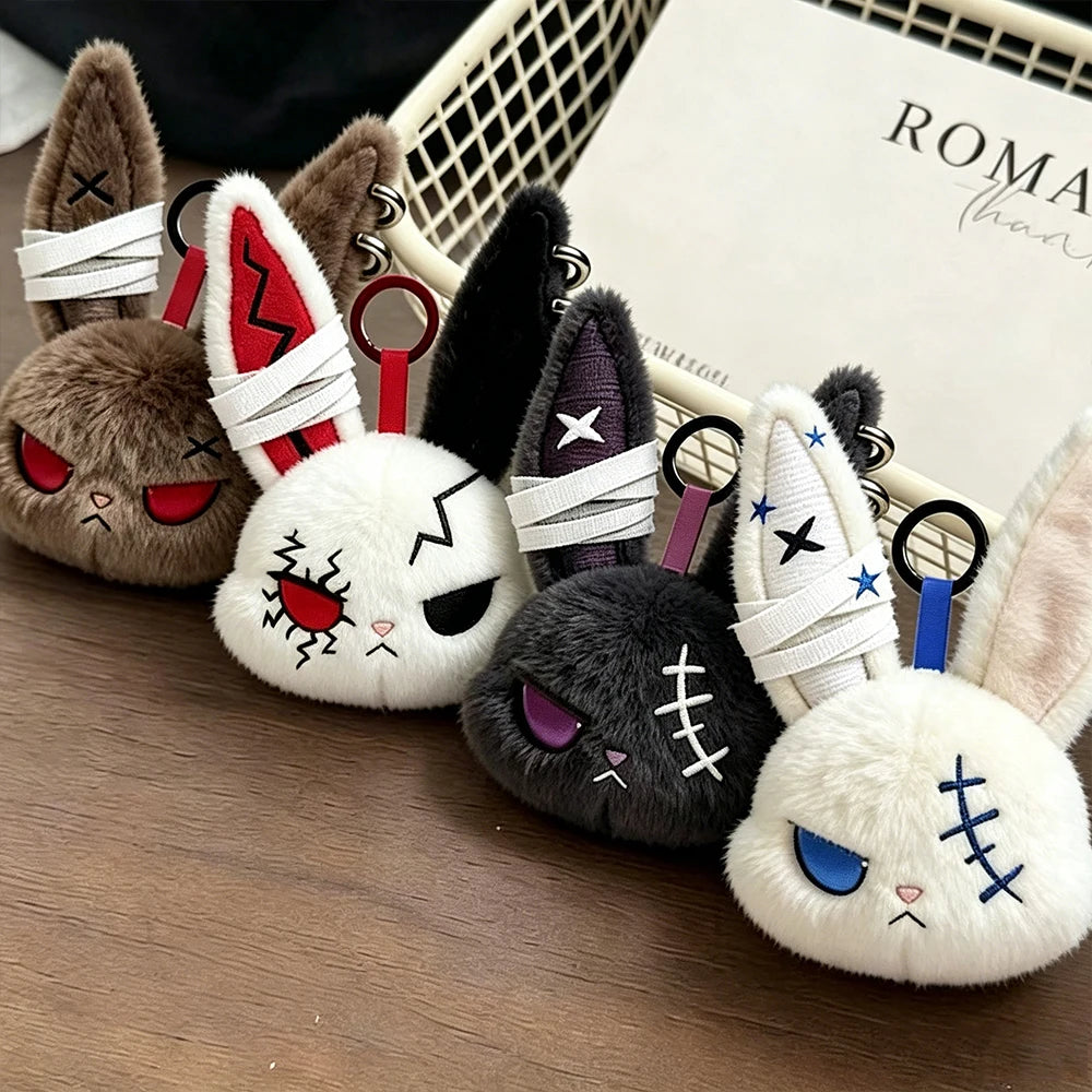 A collection of gothic bunny plush keychains with bandages and various colors displayed in a white basket.