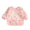 Pink full-sleeve waterproof baby bib with a cute cartoon design featuring small flowers and leaves.