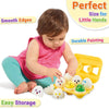 A toddler is interacting with a set of colorful, painted eggs used as a learning toy for little hands.