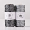 Spools of metallic yarn for knitting and crochet with black and silver threads.