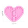 Pink heart-shaped silicone mold for resin casting with small heart cutouts