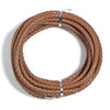A round coil of brown braided leather cord used for jewelry making and DIY crafts.