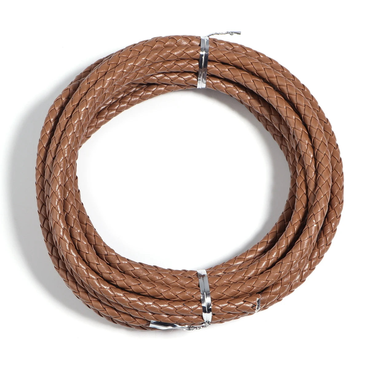 A round coil of brown braided leather cord used for jewelry making and DIY crafts.