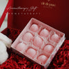 A pink silicone mold containing several round strawberry-shaped molds for crafting.