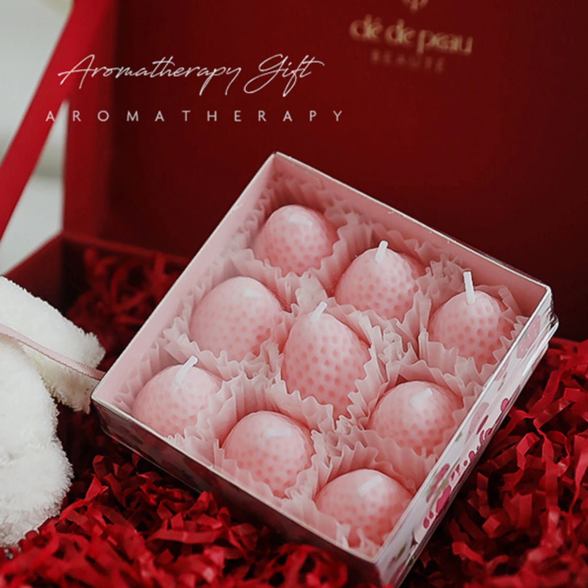 A pink silicone mold containing several round strawberry-shaped molds for crafting.