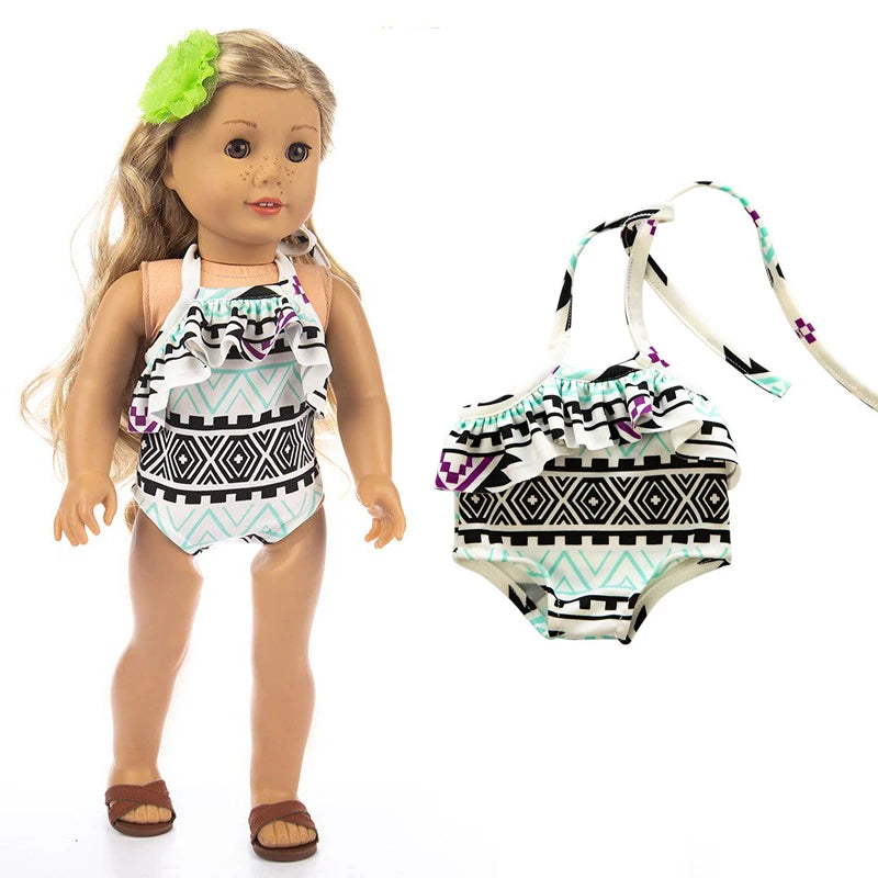 A doll wearing a light blue and black patterned outfit set with a ruffled top, skirt, and tights.