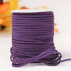 A roll of purple velvet faux suede braided ribbon used for crafting and gift wrapping.