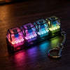 A set of glowing LED light-up keycaps arranged on a dark surface, connected by a metal keychain.