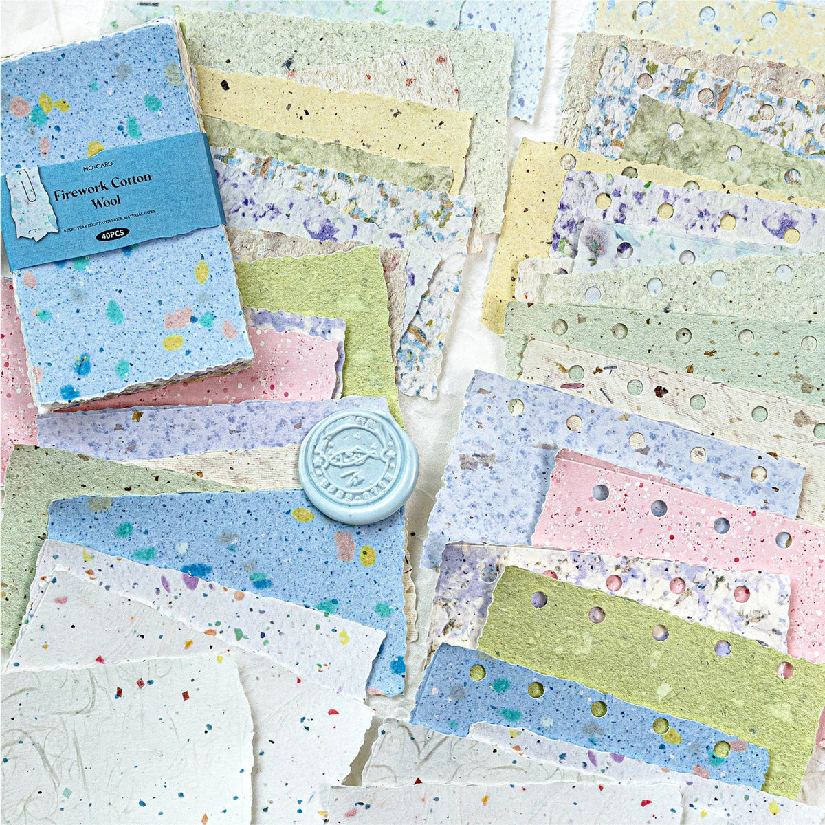 A collection of vintage scrapbooking paper sheets in various pastel colors and textures, including blue, pink, green, and yel